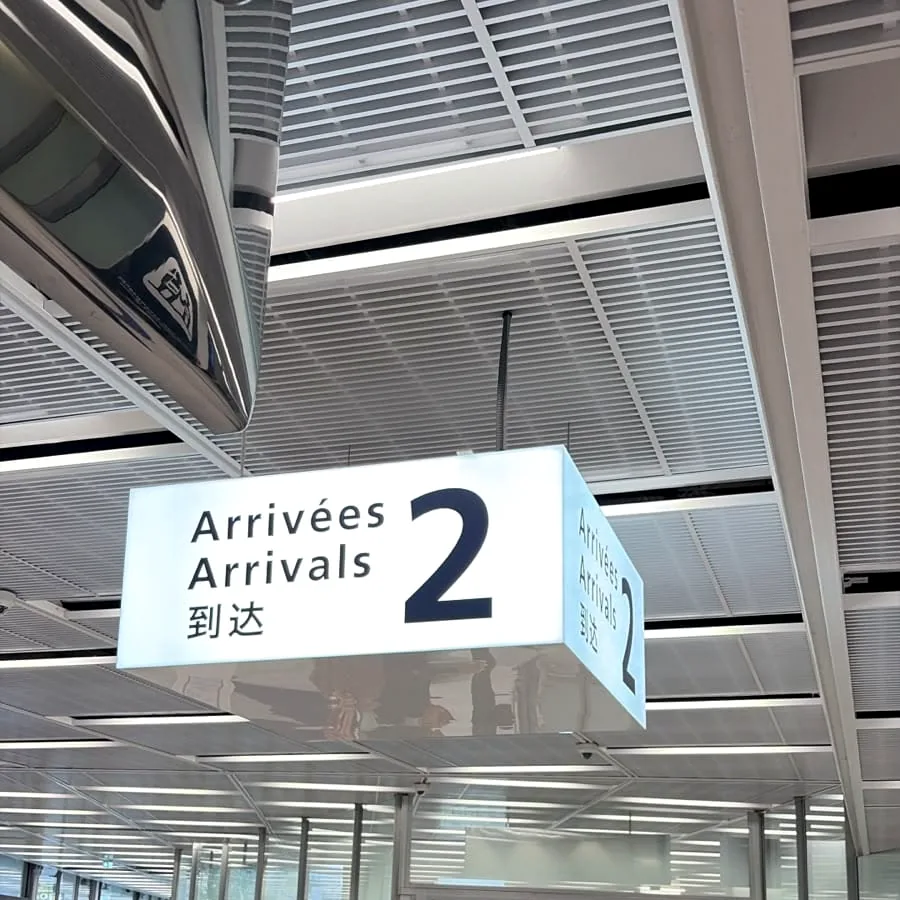 The Arrivals 2 sign inside a Paris airport terminal.