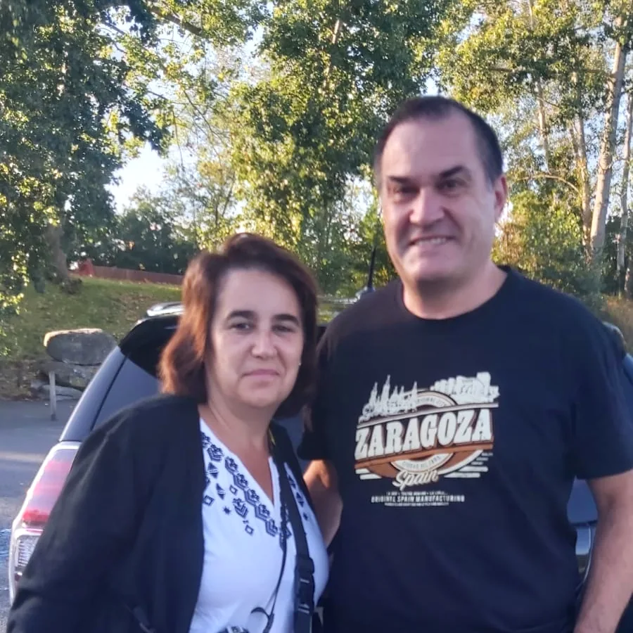 Two of our guests standing beside the car.